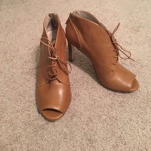 Tan zip up peep toe bootie.
