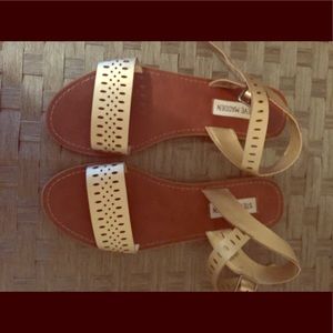 Gold Steve Madden sandals.