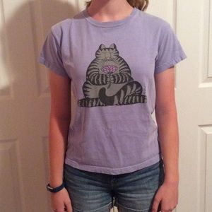 A purple t-shirt with a cat on it