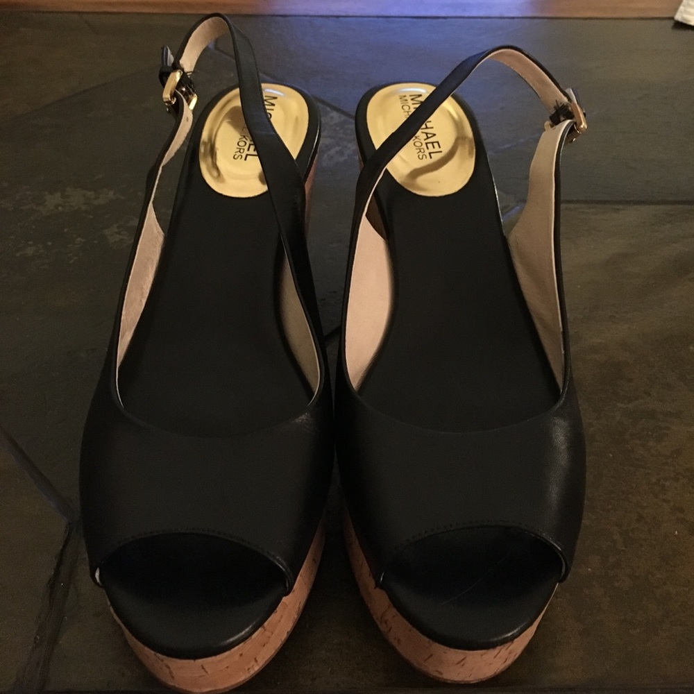 Black Michael Kors sling back peep toe wedges.