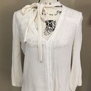 Off white blouse, ties around the neck.