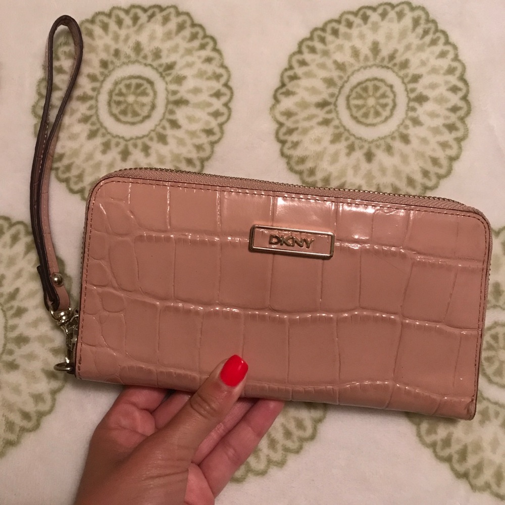 Light pink DKNY wristlet with white interior