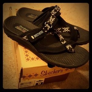 Black and white skechers sandals