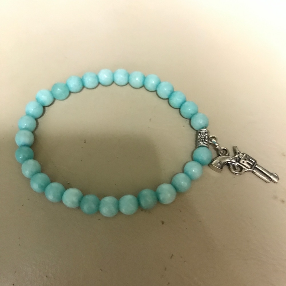 Beaded bracelet with gun charm