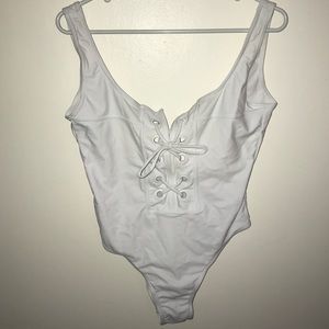 White one piece with lace up detail
