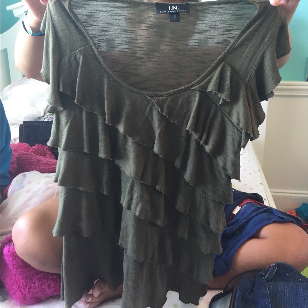 Olive green ruffled shirt.