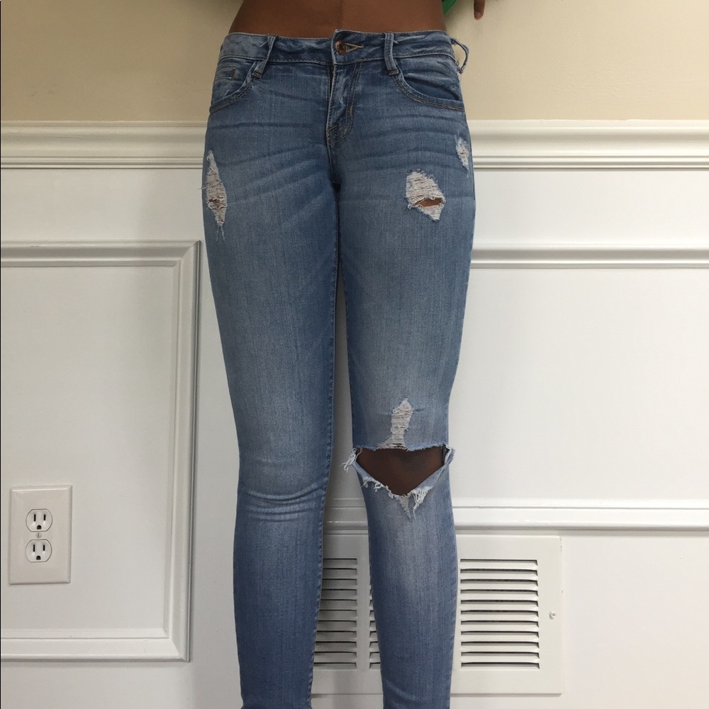 Distressed light wash denim jeans
