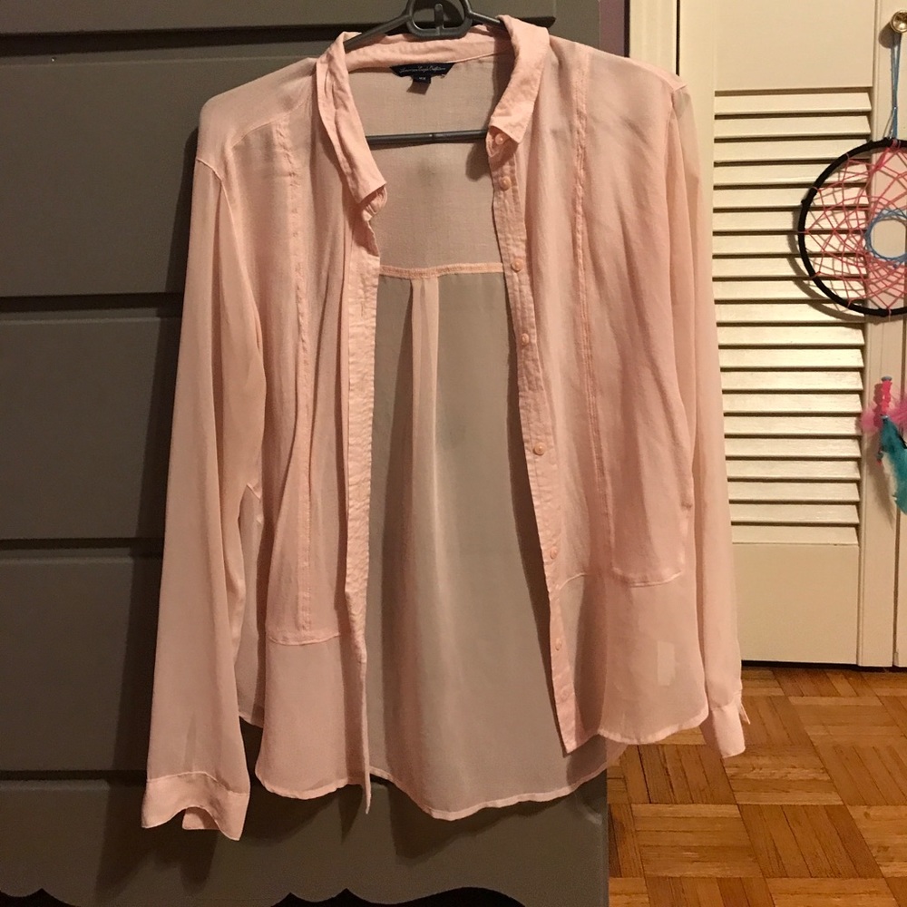 Medium blush pink blouse with see through sleeves.