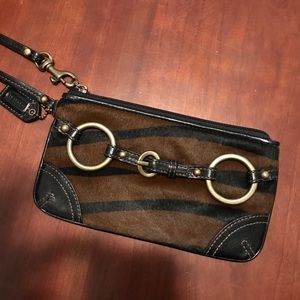 Brand new Coach leather wristlet with. All hair