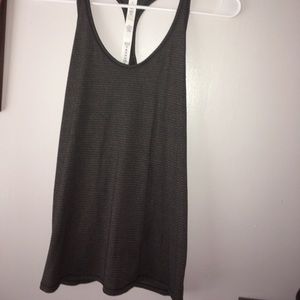 black and gold lululemon tank with slit