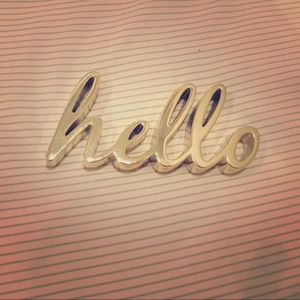 This is a cute little "hello" cursive sign!