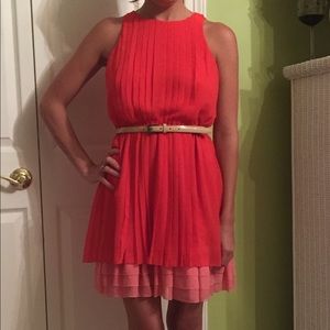 Orangey red/coral color blocked pleated dress.