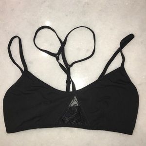 Black bralette with lace detailing by cleavage