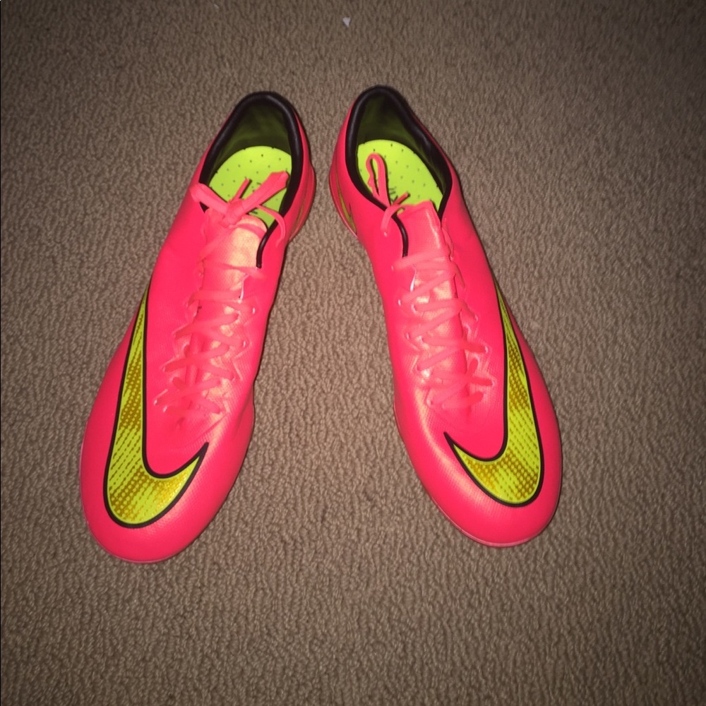 Neon colored Nike cleats with metal spikes