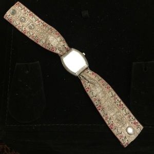Silver watch on embroidered cloth band