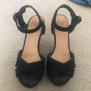 Black wedges with multi-color design on wedge.