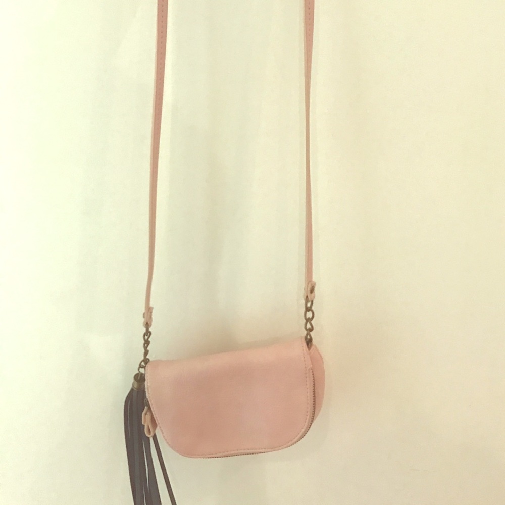 A Mossimo purse in light pink with a cute tassel