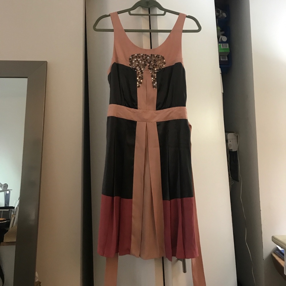 Sleeveless scoop neck dress with embellishment.