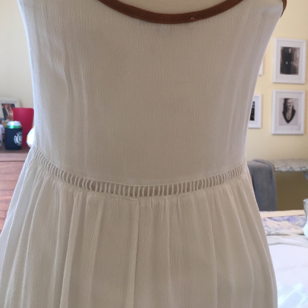 A white dress with pretty designs on the front. - Picture 4 of 6