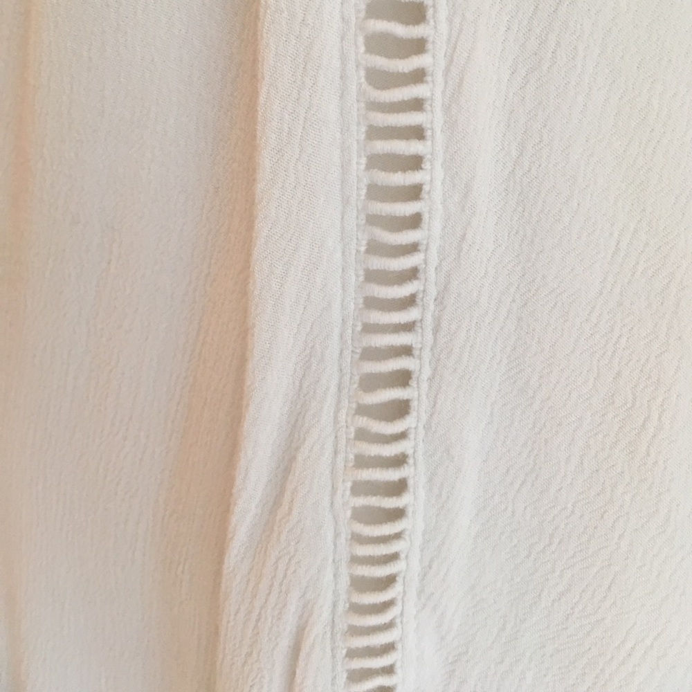 A white dress with pretty designs on the front. - Picture 6 of 6