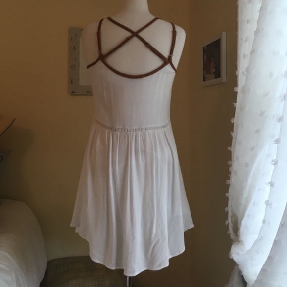 A white dress with pretty designs on the front. - Picture 2 of 6