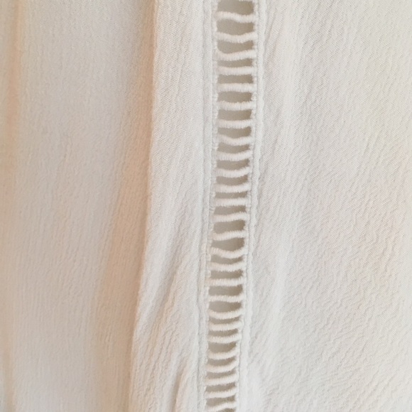 A white dress with pretty designs on the front. - Picture 6 of 6