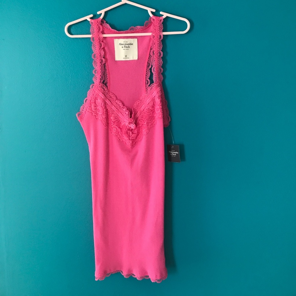 Pink form fitting tank top with lace at the top
