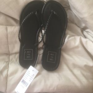 all black , braided flip flops.
