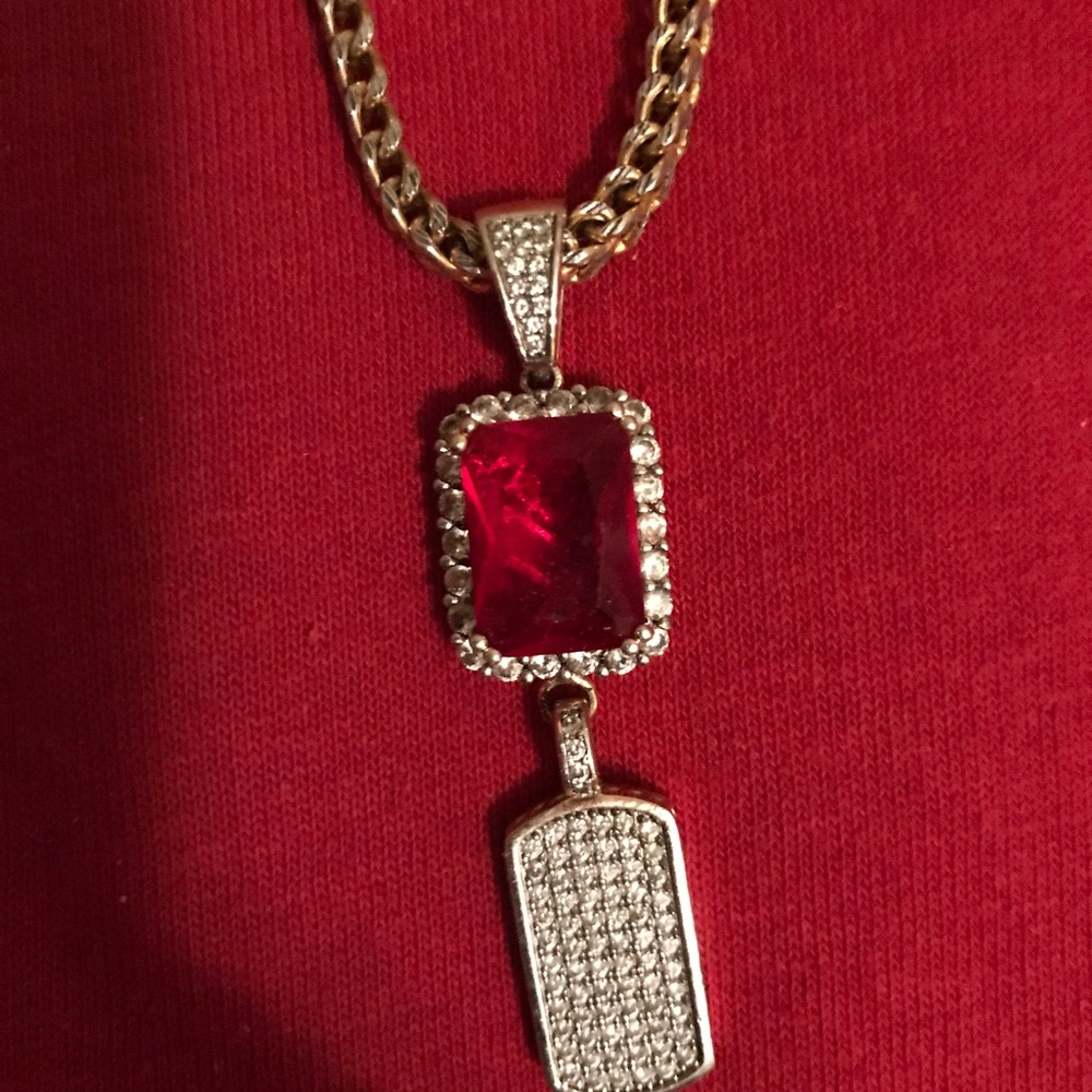 Gold chain with red ruby charm with dog tag