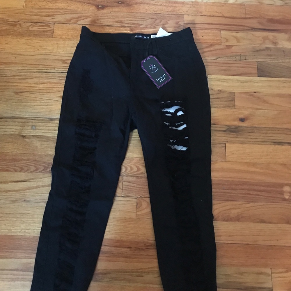 Never worn Distressed black skinny leg jeans