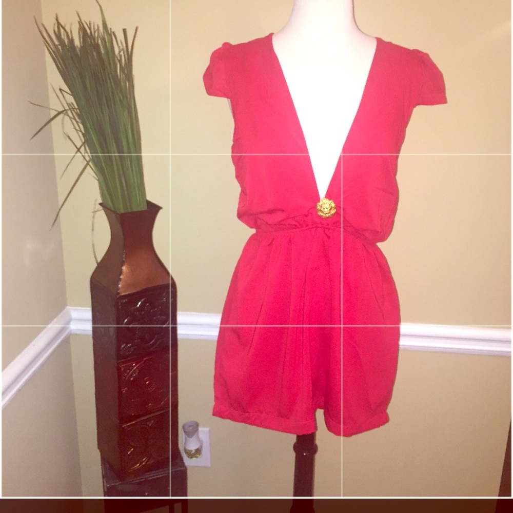 Chic romper with gold lion pendant.