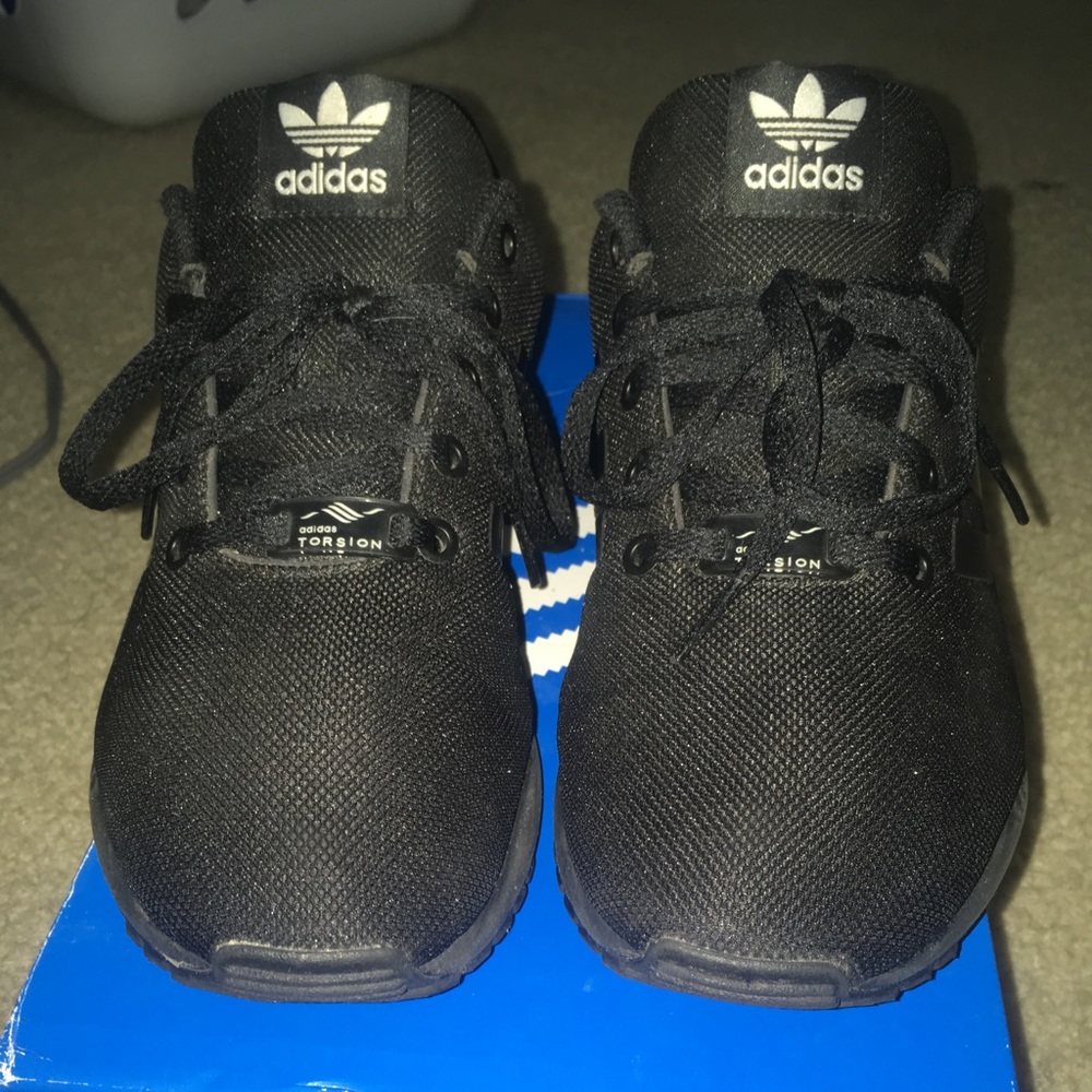all black pair of adidas shoes