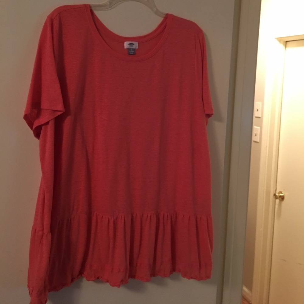 Coral colored public top with lace edging on hem