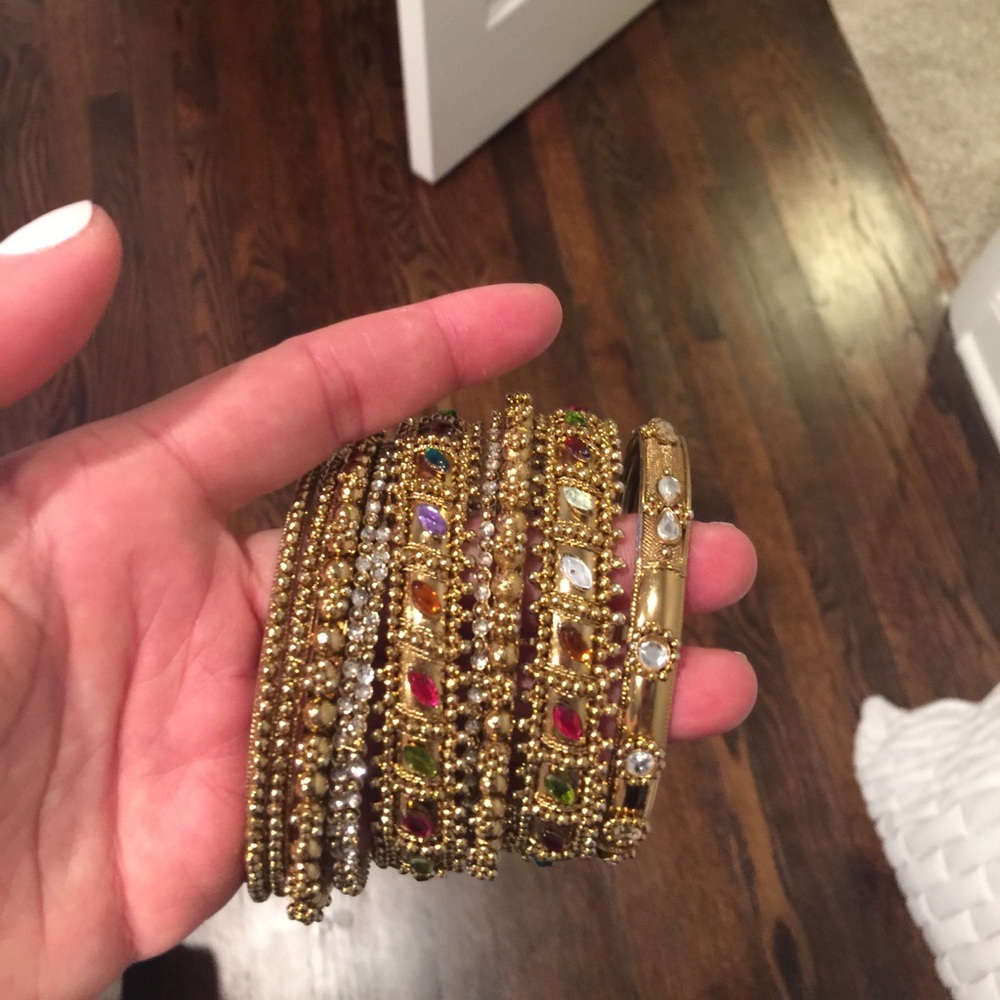 Stack of 10 gold and stone bangles