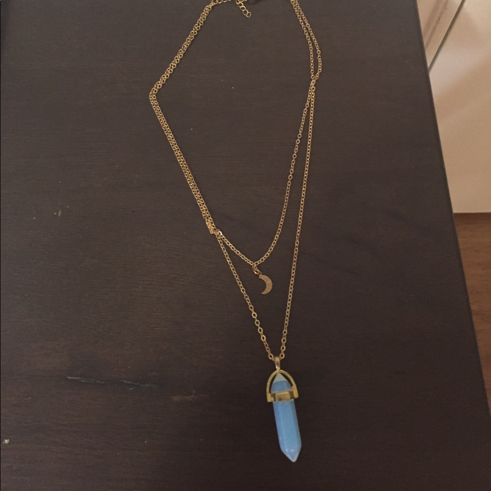 Gold necklace with an opal light crystal