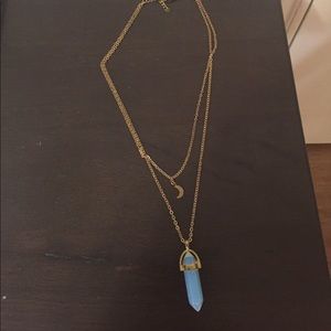 Gold necklace with an opal light crystal