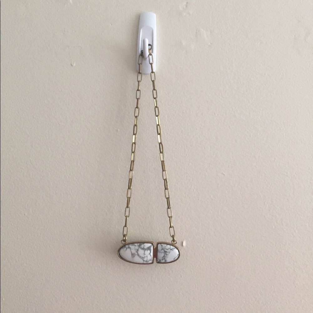 Gold and stone necklace. Marble color stone