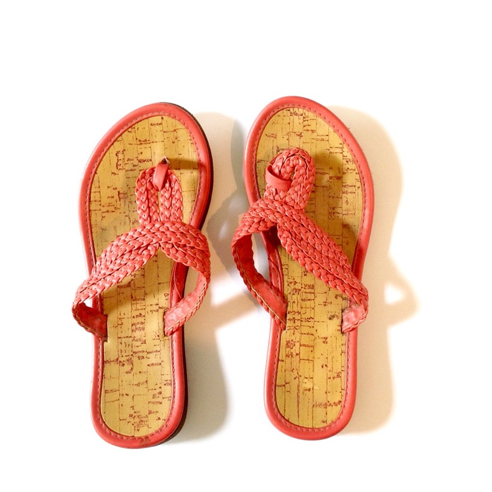 Coral/pink colored flip flops