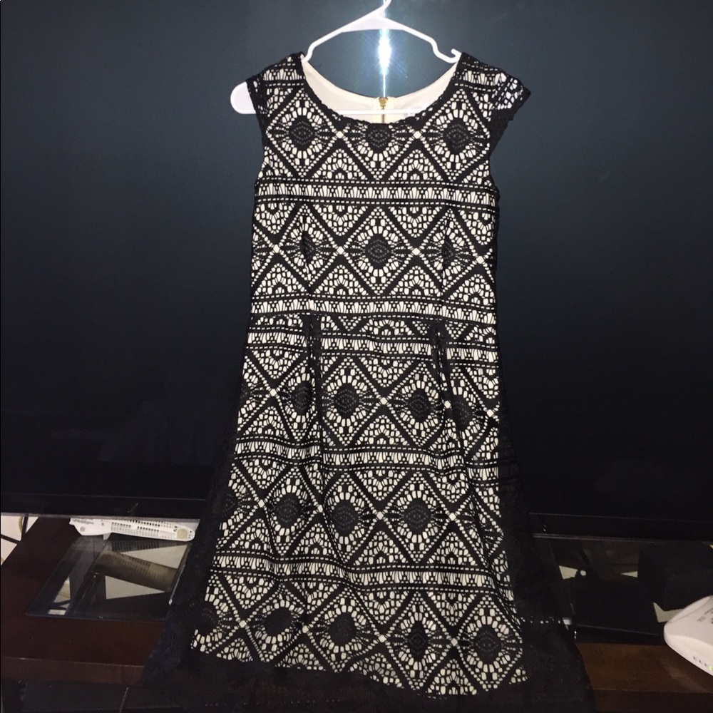 A black lace dress with a white fabric underneath
