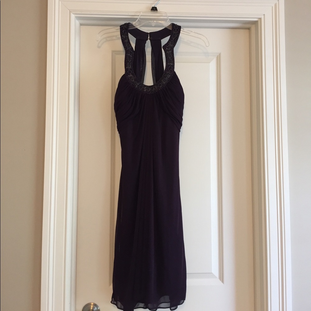 Purple cocktail dress with embellishment.