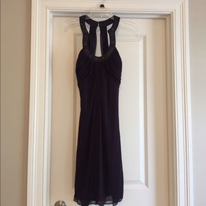 Purple cocktail dress with embellishment.