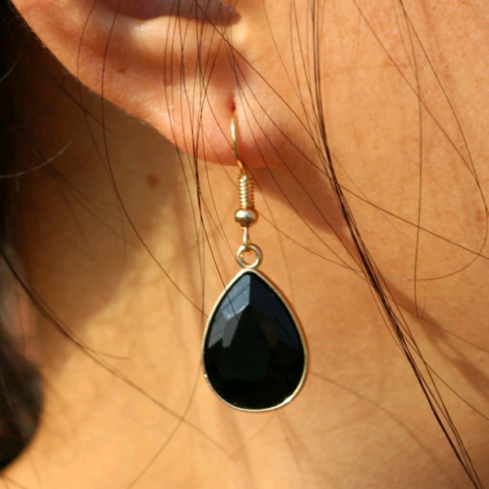 Black earrings in gold setting