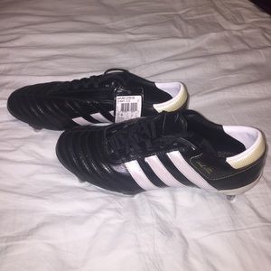 Black and white striped adidas soccer cleats