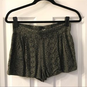 green and black patterned shorts