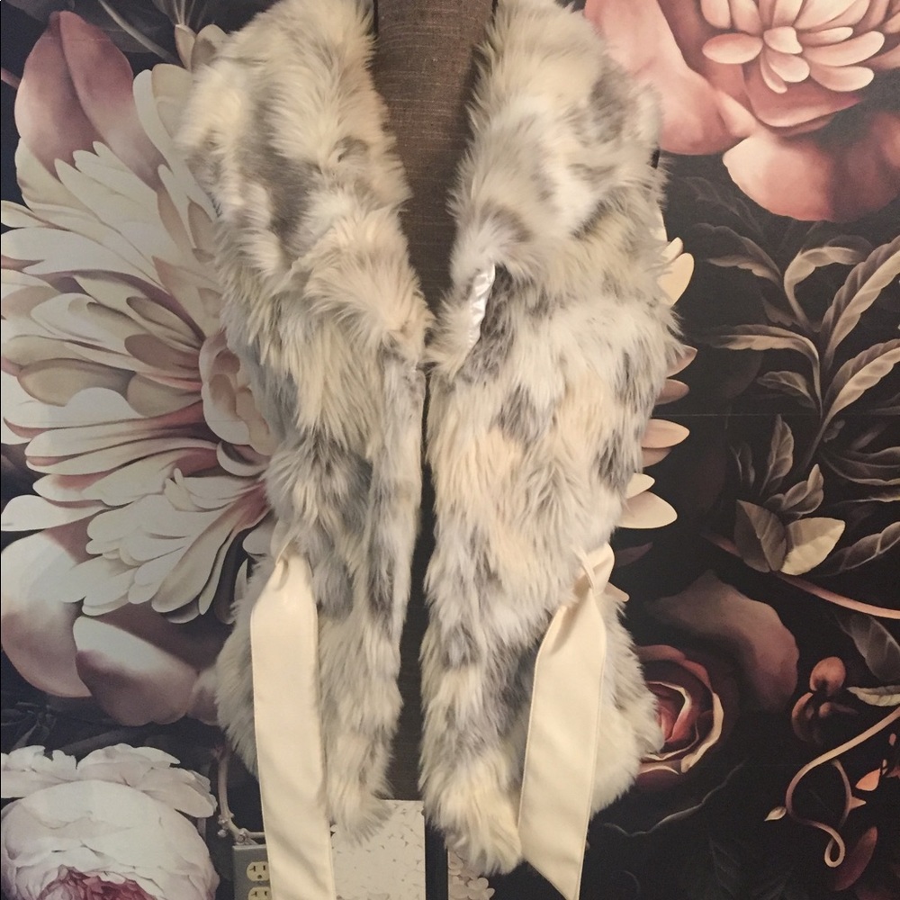 Faux fur vest with belt.