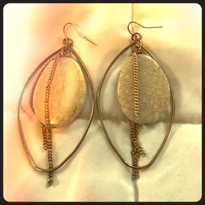 Gold oval hoop earrings with stone center