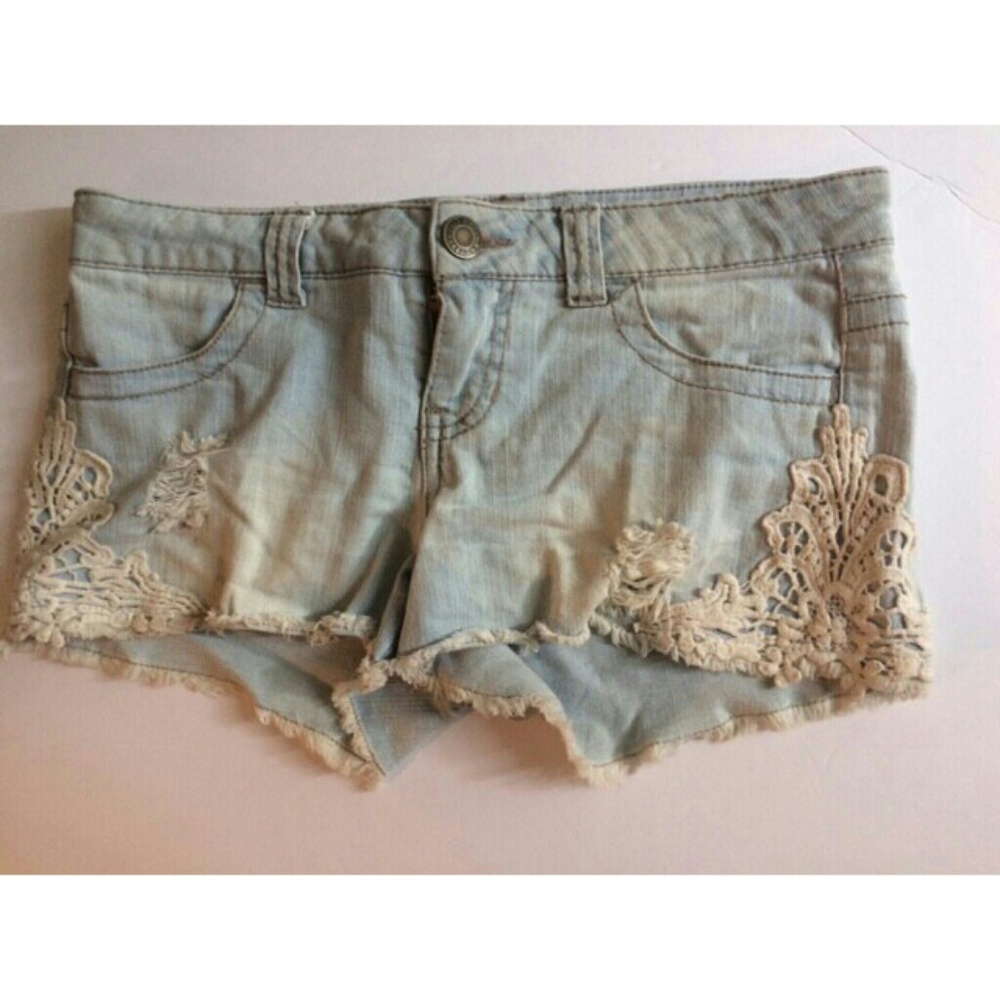 Faded distressed lace trimmed denim shorts