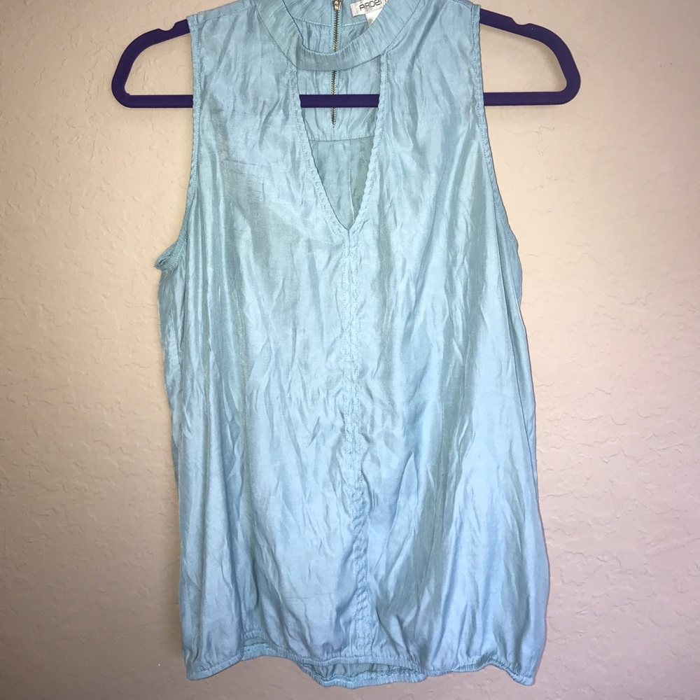 A pastel blue with cut out neck and gold zipper ❄️