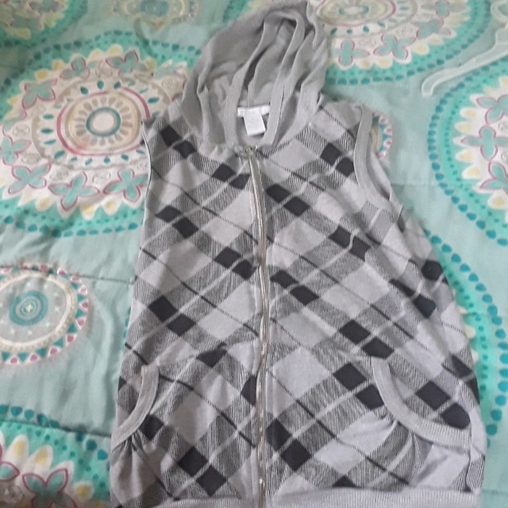 A grey and black checker vest with pockets