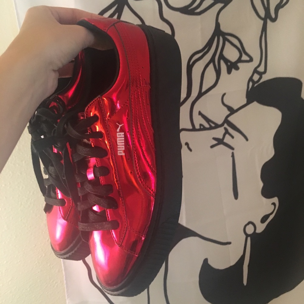 Red metallic PUMA shoes with black soles. NWOT